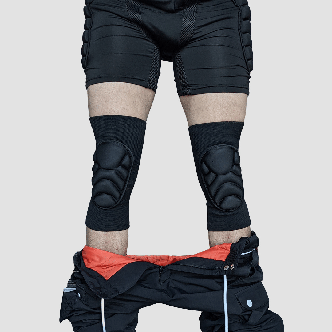 Front view of Snowboarder wearing protective padded knee pads